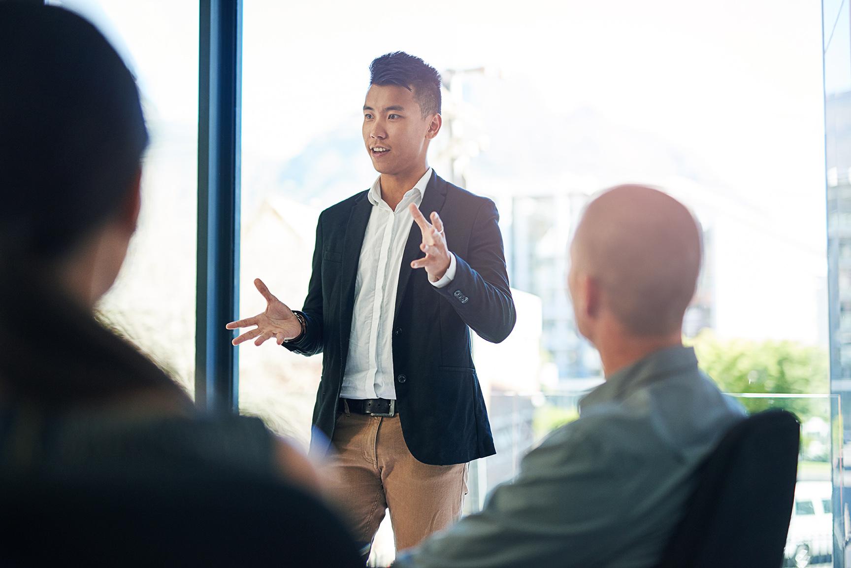 Business professional presenting to a group.